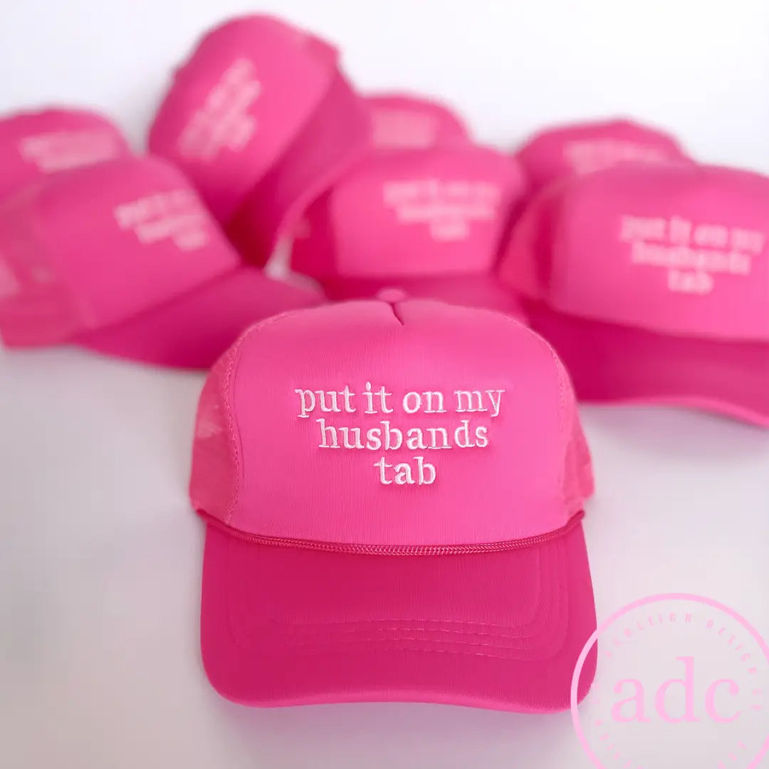 Put It  On My Husbands Tab Trucker Hat